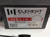 a black box with a red and white label on it and a pair of scissors in front of it