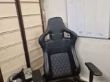 a black and white office chair in front of a white board