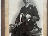 an old photo of a man in a military uniform holding a hat