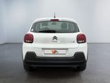 the rear of a white citrole parked in a white room