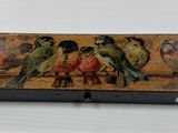 a box with birds painted on it sitting on a table