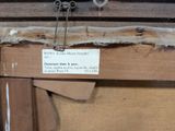 a sign on a piece of wood with a pair of scissors attached to it