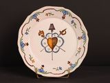 a white plate with a heart and two birds on it