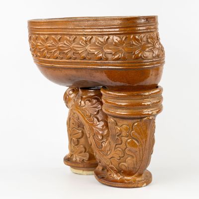 un grand bol en bois posé sur un socle, sur fond blanc