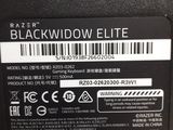 the back of a black laptop with a bar code on it