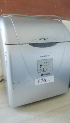 a silver toaster sitting on the floor next to a wall
