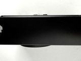 an image of a black camera on a white surface