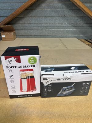 two boxes of popcorn maker sitting on top of a wooden table