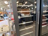 two glass doors that are open in a store