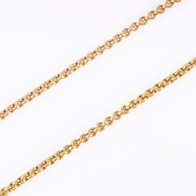 a close up of a gold chain on a white background