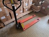a fork lift in the middle of a room filled with boxes