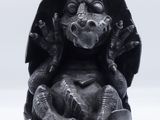 a statue of a dragon sitting on top of a bowl