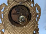 a gold clock that is sitting on a table