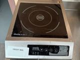 a small stove with a black burner on top of it