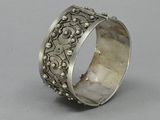 a close up of a silver ring on a gray surface