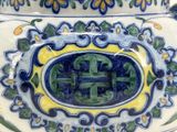 a blue and yellow vase sitting on a table