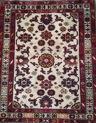 an oriental rug with a floral design on a white ground