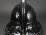 a close up of a black helmet on a gray surface