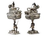 pair of silver plated vases with figurines of people on them