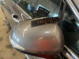 mirror of a car with a measuring tape on the side of it