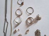 many different rings and necklaces laid out on a table