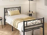 a bed with a metal frame in a room with white walls