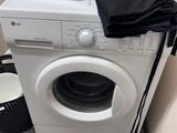 a washer and dryer in the corner of a room