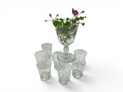 a glass vase with a flower in it on a table