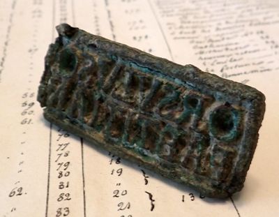 a small bronze plaque on top of an old book