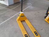 yellow forklifts in a warehouse with pallets in the background