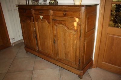 an image of a wooden cabinet with a vase on top of it