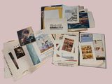 a pile of books with pictures on them on a pink background
