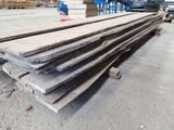 several pieces of wood are stacked on top of each other in a warehouse
