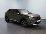 the grey suv is parked in a room with a white wall