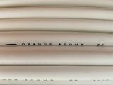 several white surfboards stacked on top of each other on a wooden surface
