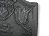 a metal plaque with a design on it on a white background