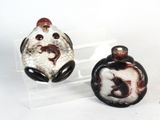 two glass figurines that are sitting on a table