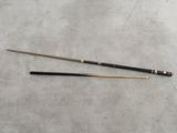 an old snooker cue and an old billiard cue on a table