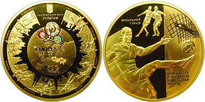 a close up of a gold coin with a soccer player on it