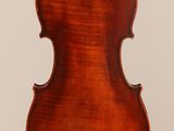an antique violin with a wooden back and a long neck