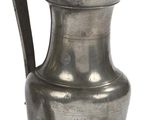 an old silver pitcher with a handle on a white background