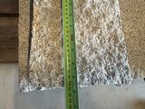 a measuring tape that is next to a piece of concrete
