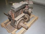 a small engine sitting on a pallet in a garage
