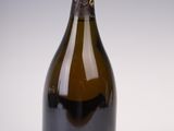 bottles of wine are lined up in a row on a white surface