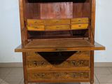 a wooden cabinet with drawers on top of it