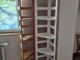 a corner shelf in the corner of a room next to a window
