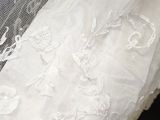 a close up of a wedding dress on a mannequin