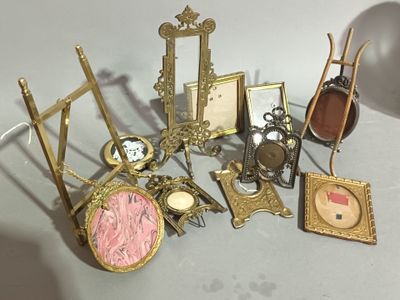 a lot of antique picture frames and pictures on the table