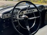 the interior of an old car with a steering wheel and dashboard