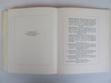 an open book with a poem on it sitting on a table